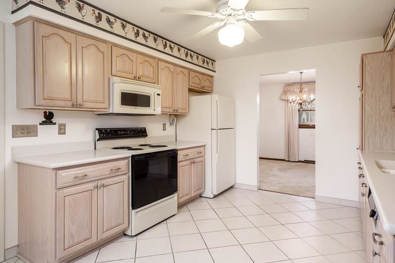 1110 Roxbury Close Rockford, IL 61107 - Photo 7 of 36 a kitchen with white cabinets and white appliances