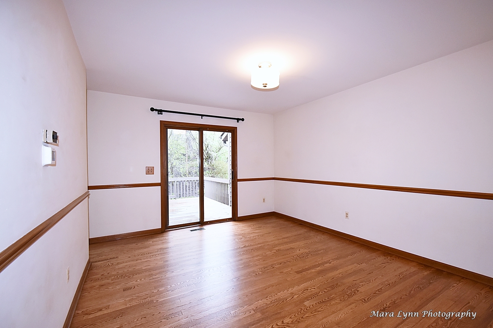 112 Sumac Court St. Charles, IL 60174 - Photo 13 of 37 a view of an empty room with wooden floor and a window