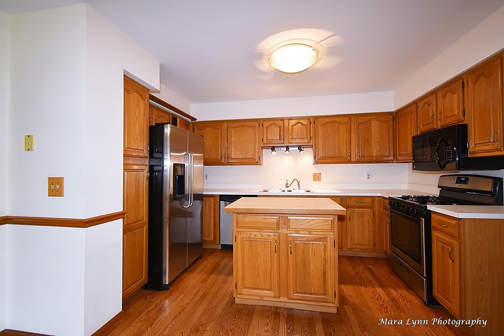 112 Sumac Court St. Charles, IL 60174 - Photo 16 of 37 a kitchen with stainless steel appliances granite countertop a refrigerator a stove top oven a sink and dishwasher