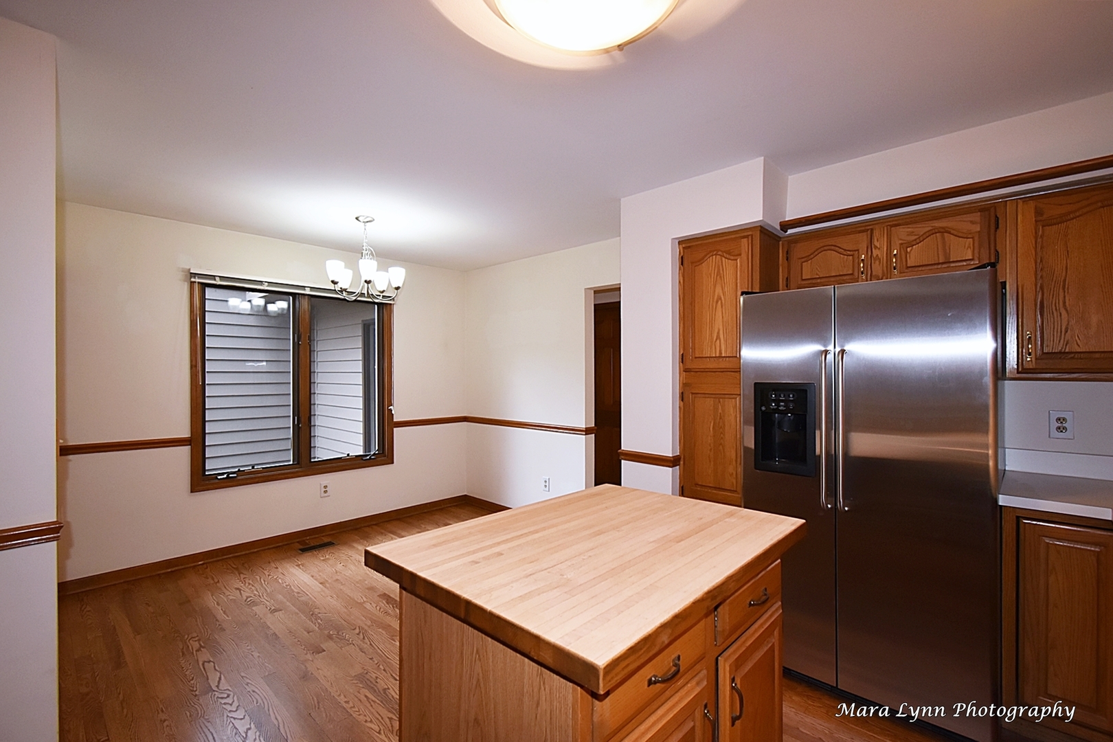 112 Sumac Court St. Charles, IL 60174 - Photo 17 of 37 a kitchen with kitchen island a refrigerator sink and wooden floor