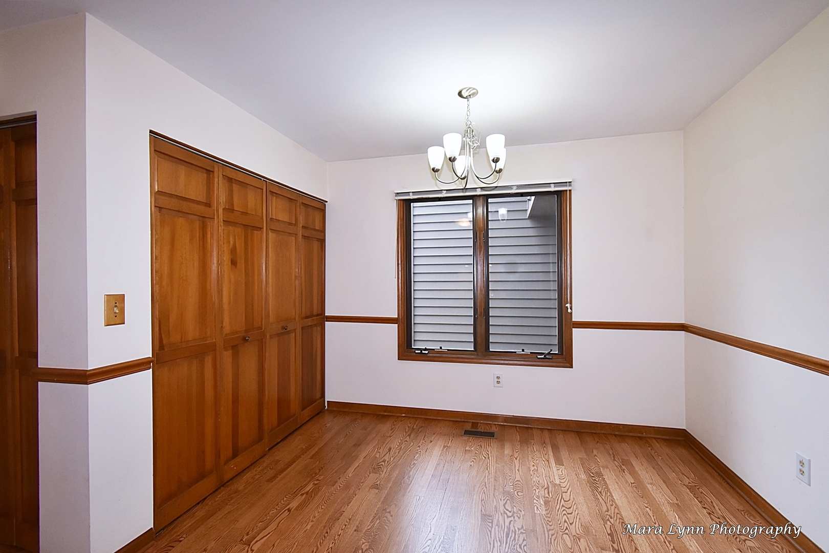 112 Sumac Court St. Charles, IL 60174 - Photo 18 of 37 an empty room with wooden floor chandelier and windows