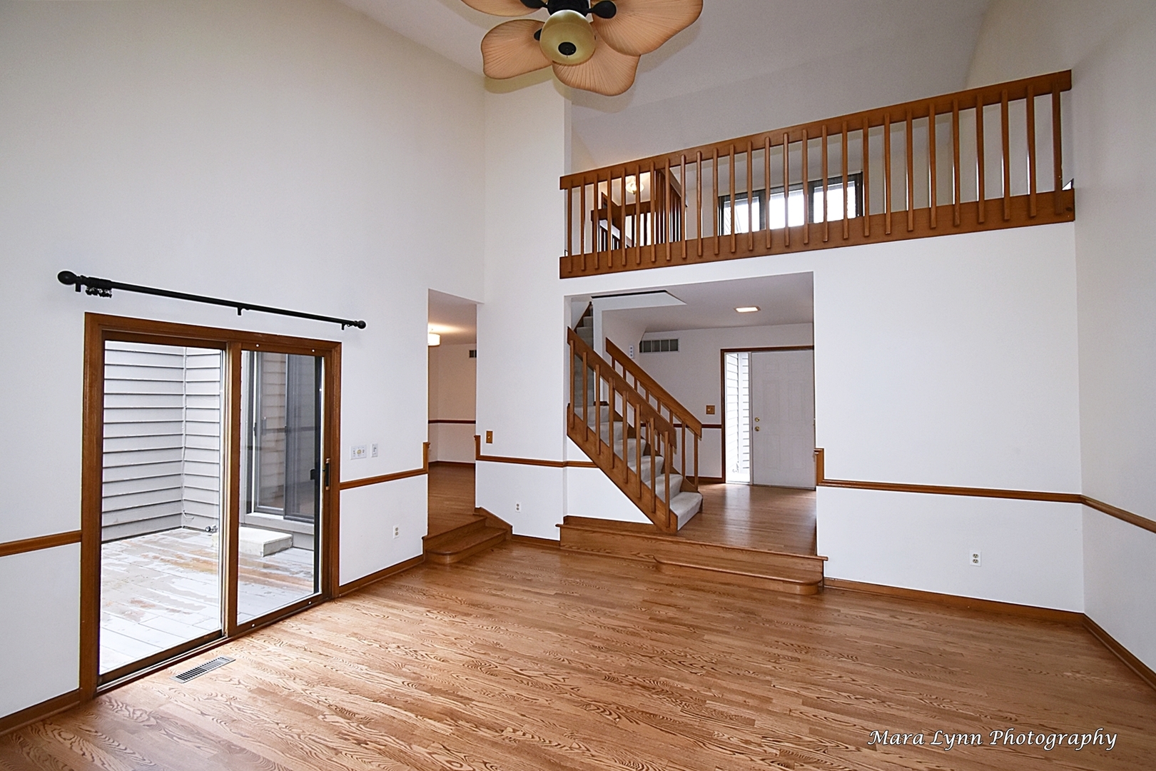 112 Sumac Court St. Charles, IL 60174 - Photo 10 of 37 a view of staircase with lots of frames and a wooden floor