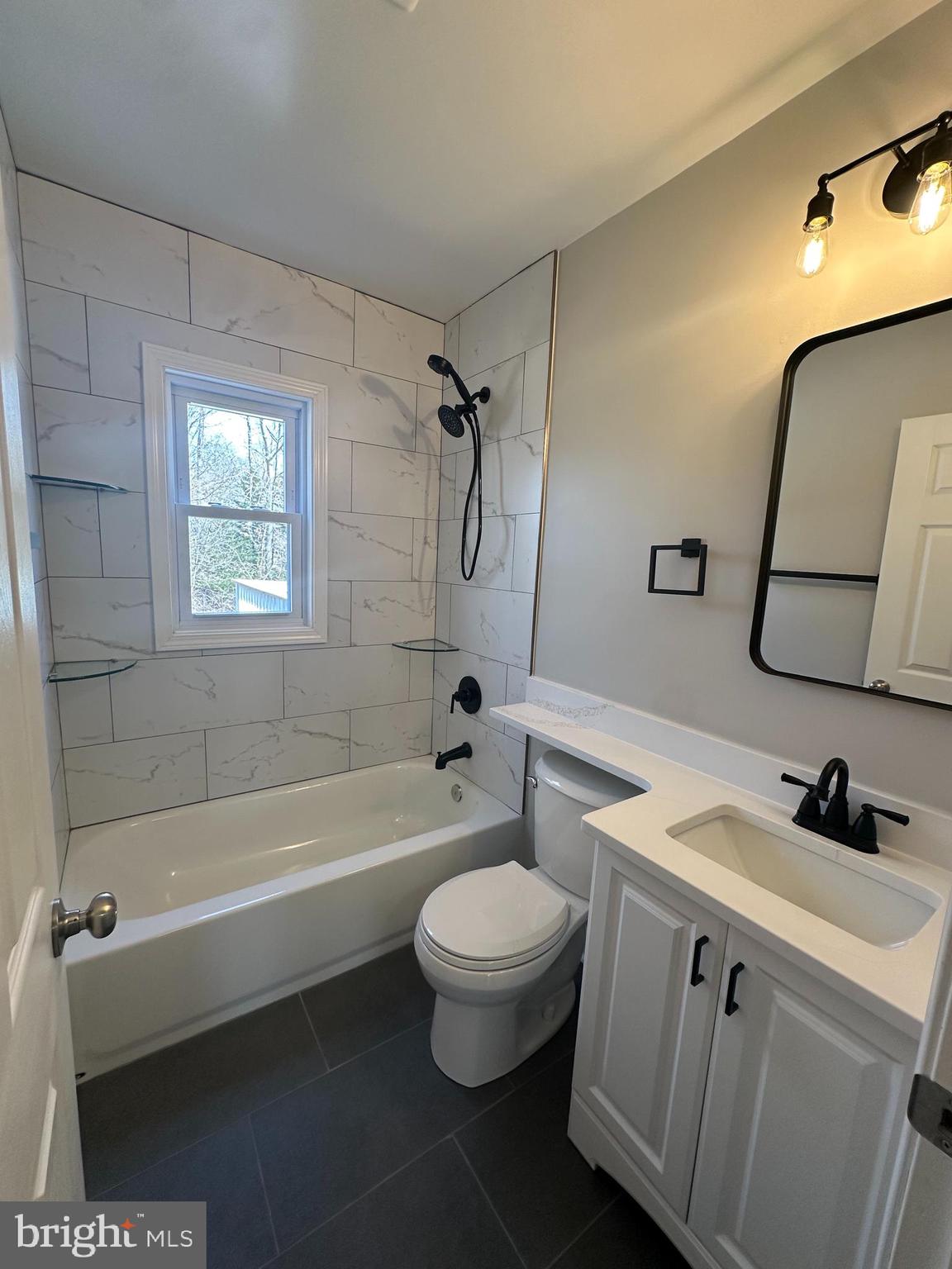 11160 Tippett Road Clinton, MD 20735 - Photo 12 of 37 a bathroom with a sink a toilet and a mirror