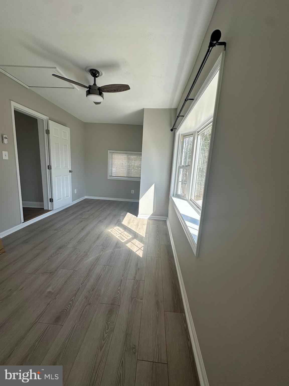 11160 Tippett Road Clinton, MD 20735 - Photo 19 of 37 wooden floor in an empty room with a window