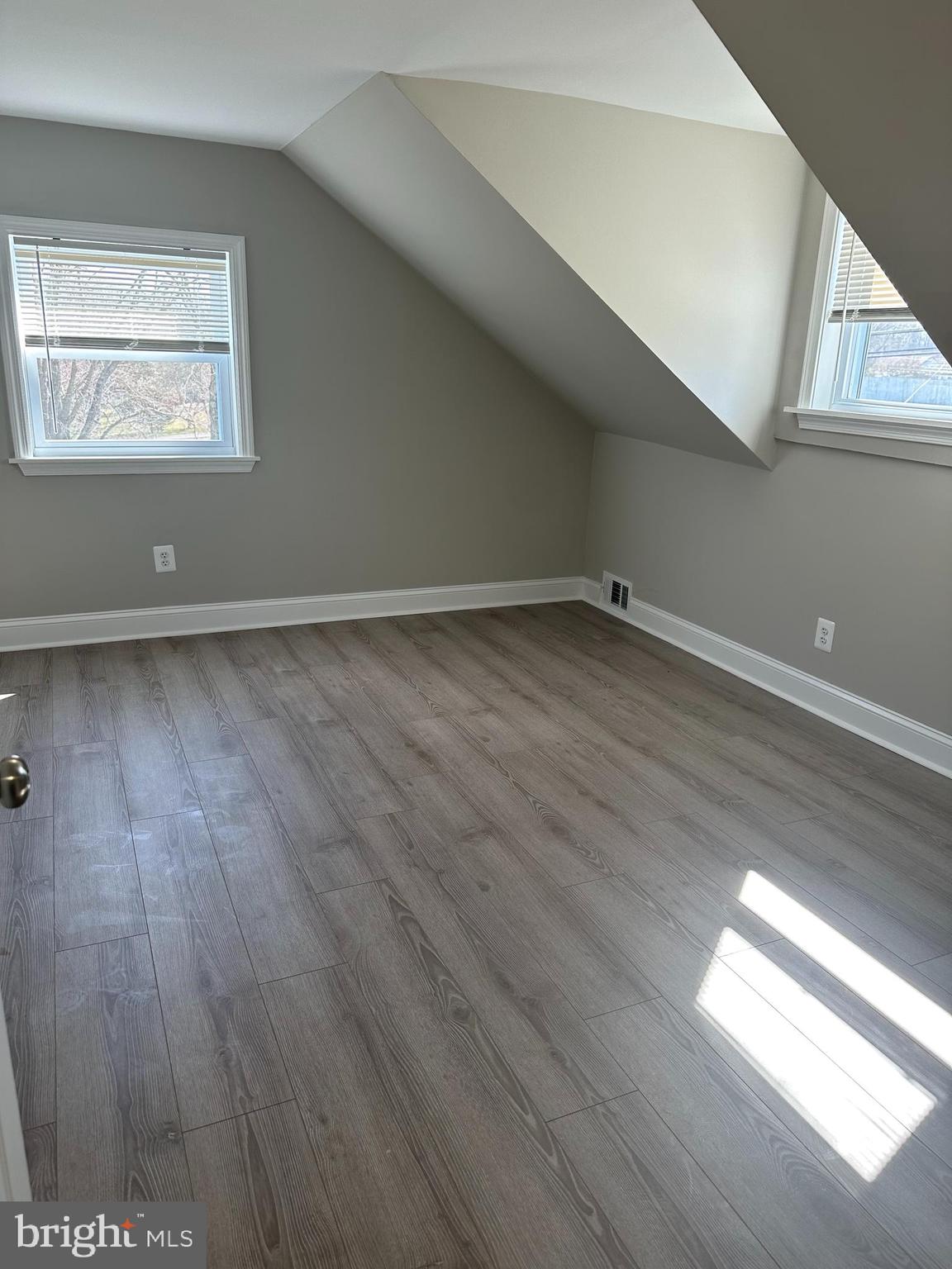 11160 Tippett Road Clinton, MD 20735 - Photo 20 of 37 an empty room with wooden floor and windows
