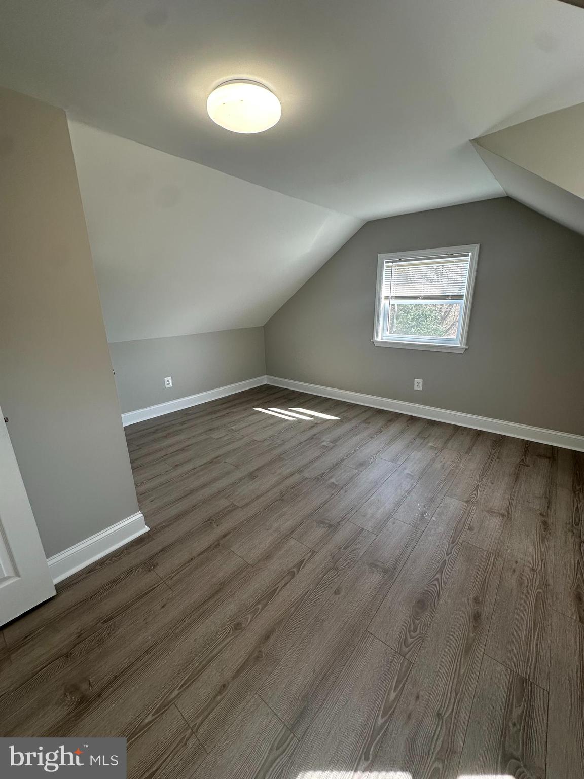 11160 Tippett Road Clinton, MD 20735 - Photo 21 of 37 an empty room with wooden floor and windows