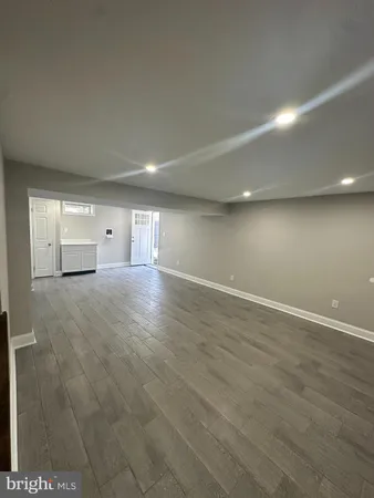 a room with wooden floor and window