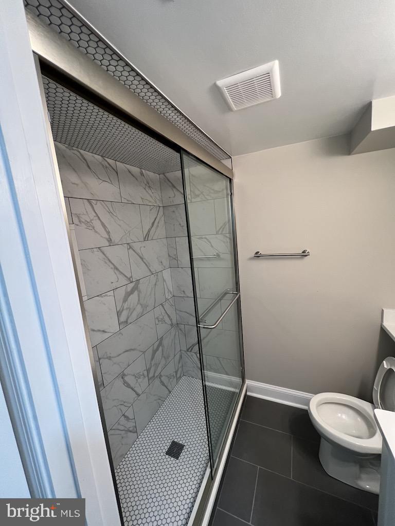 11160 Tippett Road Clinton, MD 20735 - Photo 31 of 37 a bathroom with a toilet and a shower