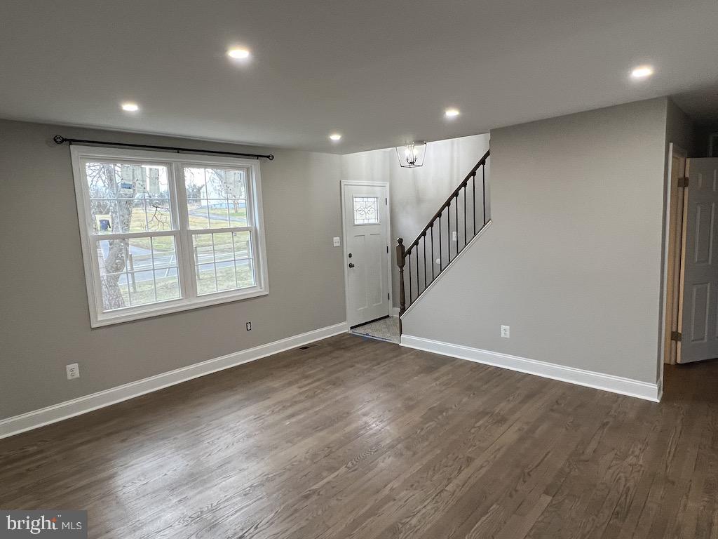 11160 Tippett Road Clinton, MD 20735 - Photo 7 of 37 an empty room with wooden floor and windows
