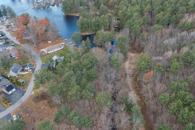 an aerial view of a house with lots of trees