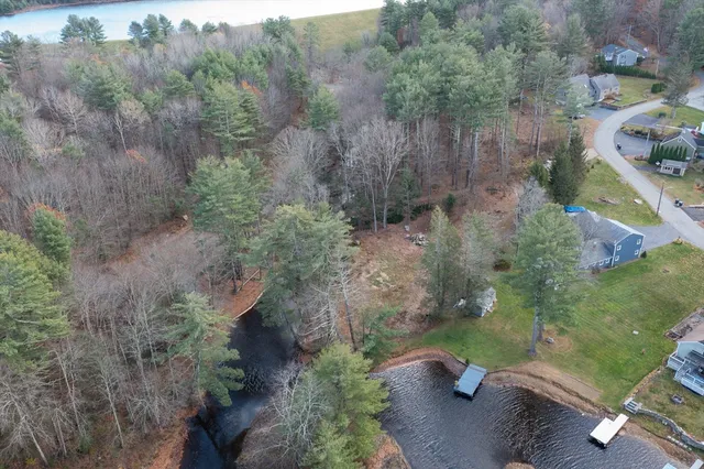 an aerial view of a house with a yard