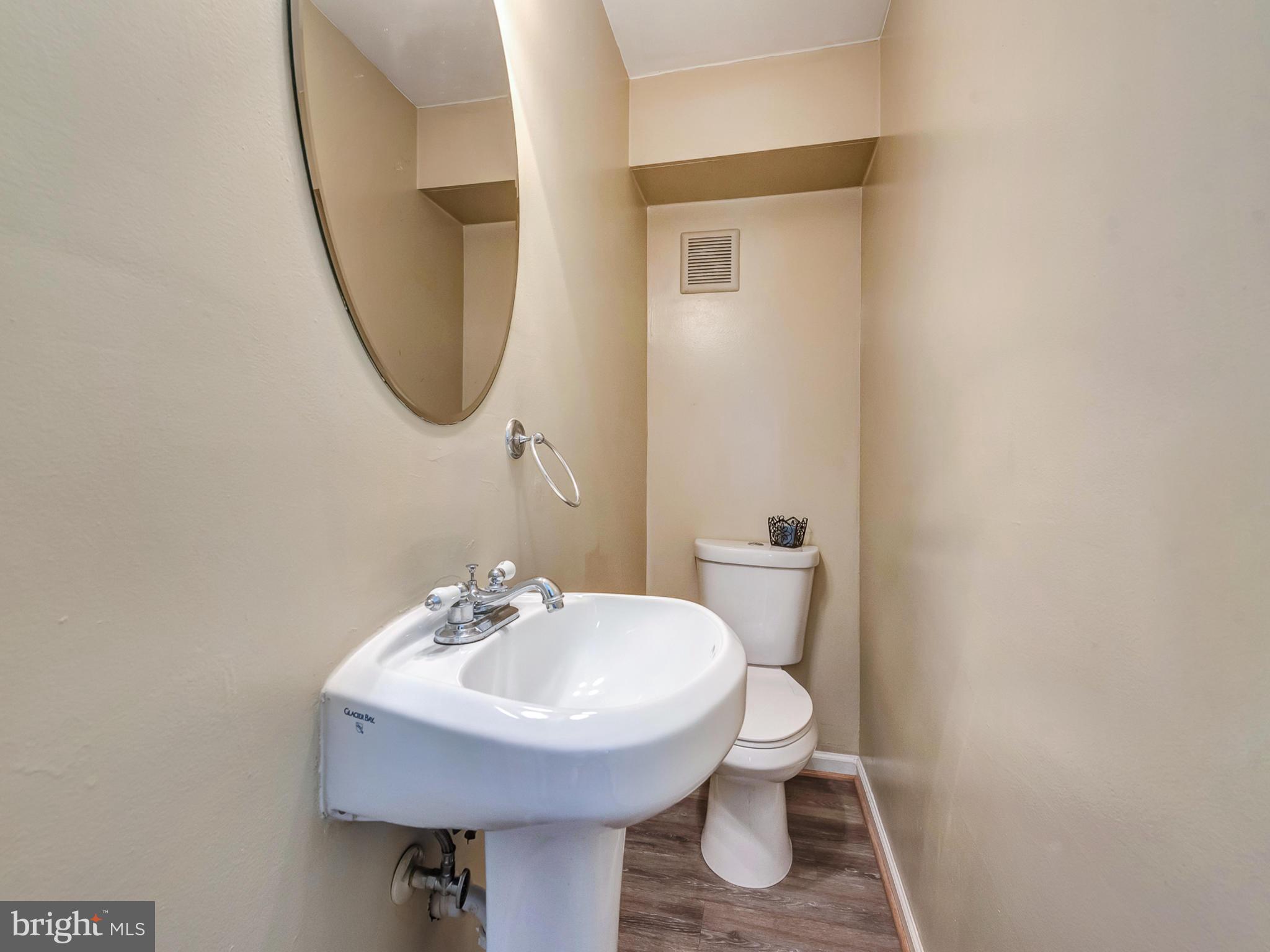 5812 Shookstown Road Frederick, MD 21702 - Photo 14 of 31 a bathroom with a sink toilet and a mirror