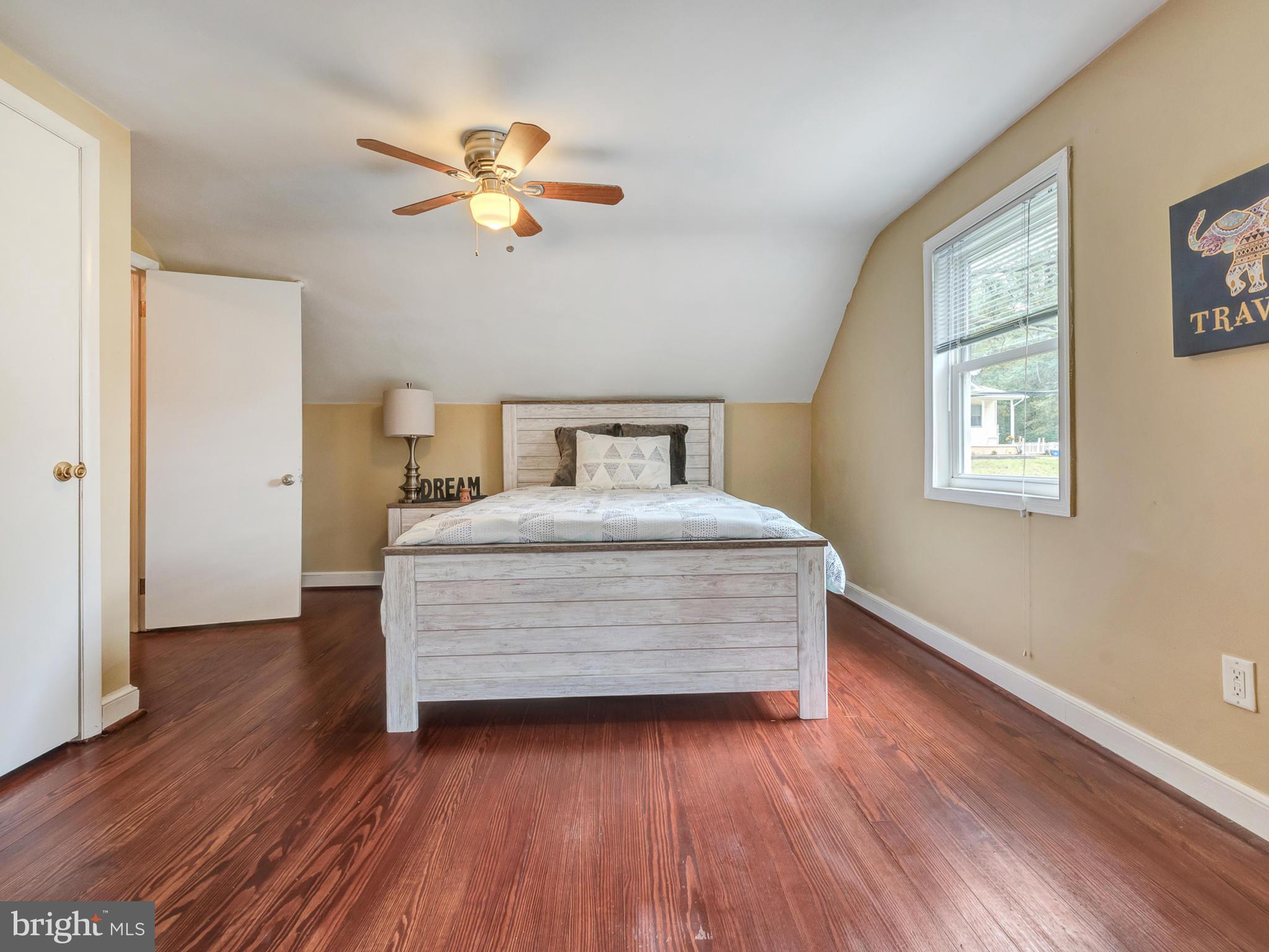 5812 Shookstown Road Frederick, MD 21702 - Photo 17 of 31 a room with a bed and wooden floor