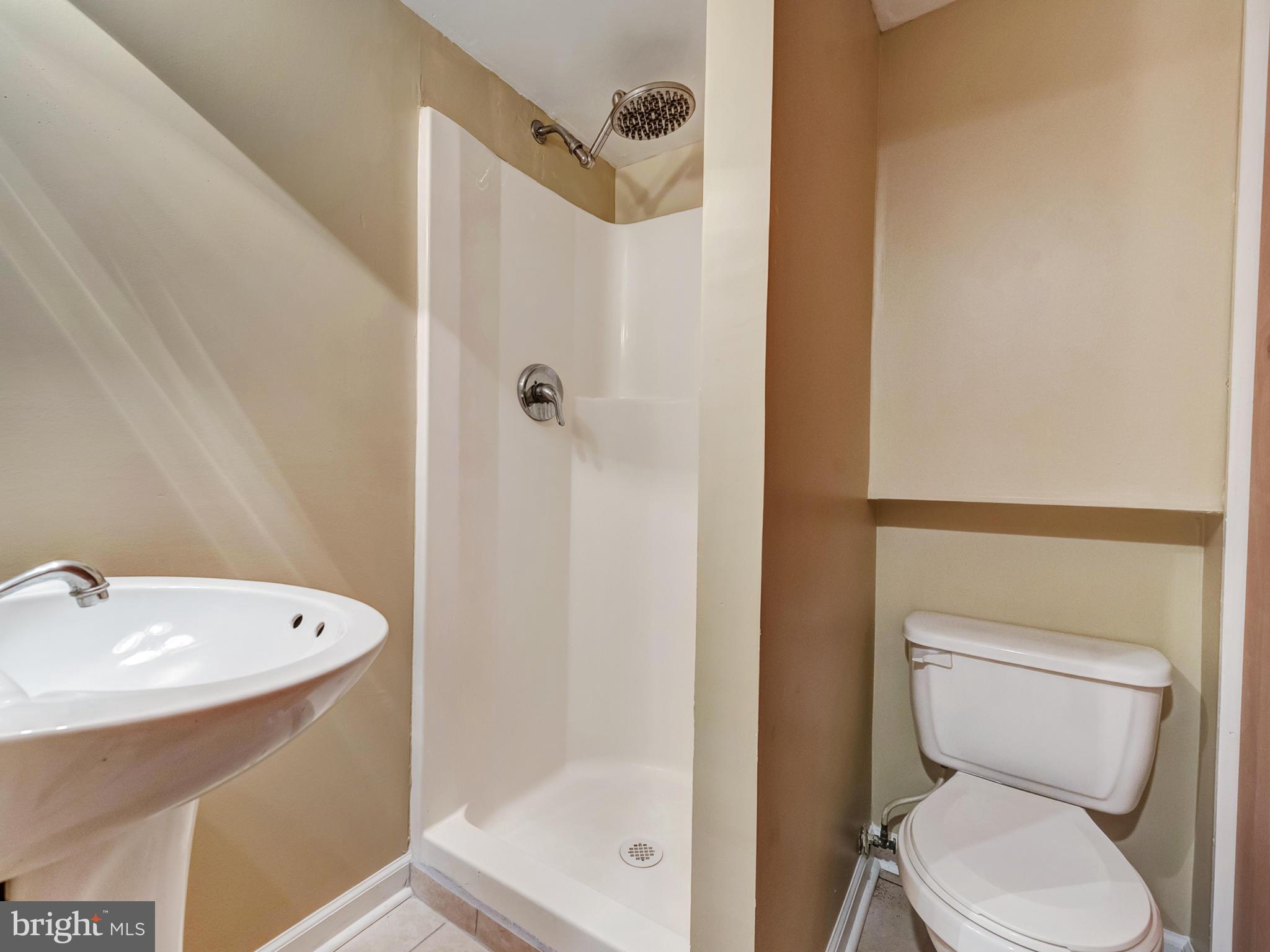 5812 Shookstown Road Frederick, MD 21702 - Photo 24 of 31 a bathroom with a toilet a sink and shower