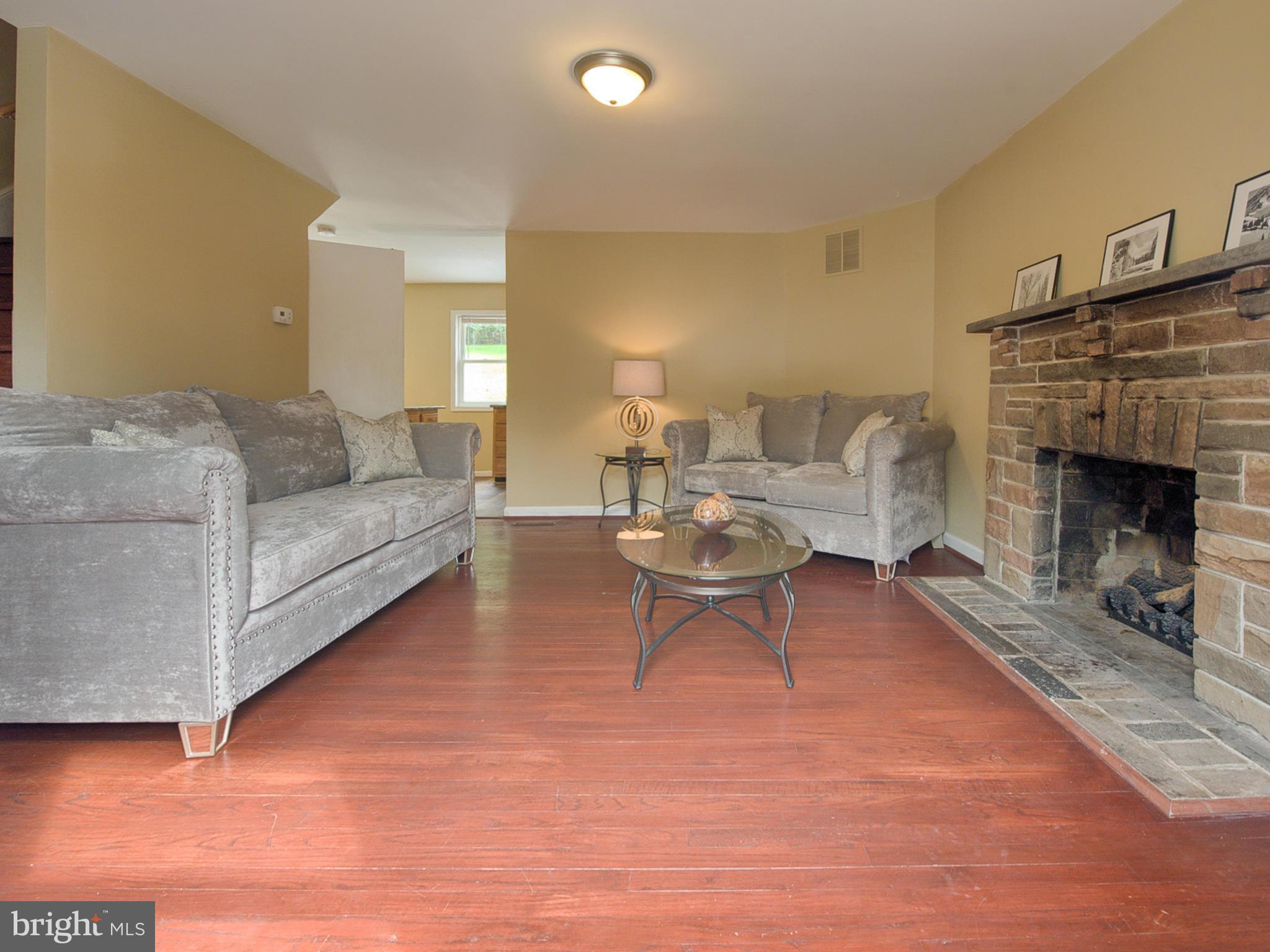 5812 Shookstown Road Frederick, MD 21702 - Photo 6 of 31 a living room with furniture and a fireplace