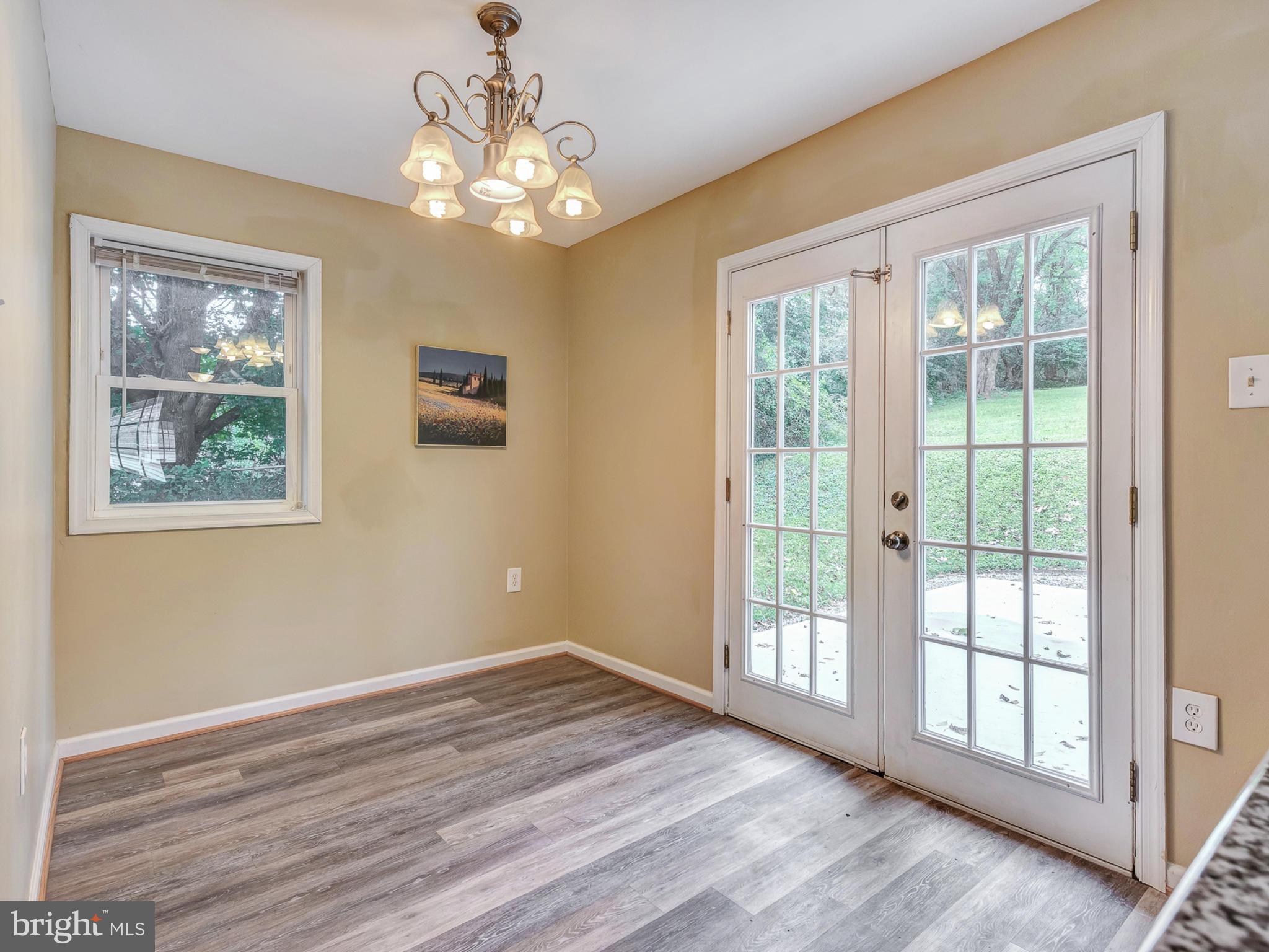 5812 Shookstown Road Frederick, MD 21702 - Photo 9 of 31 a view of an empty room with wooden floor and a window
