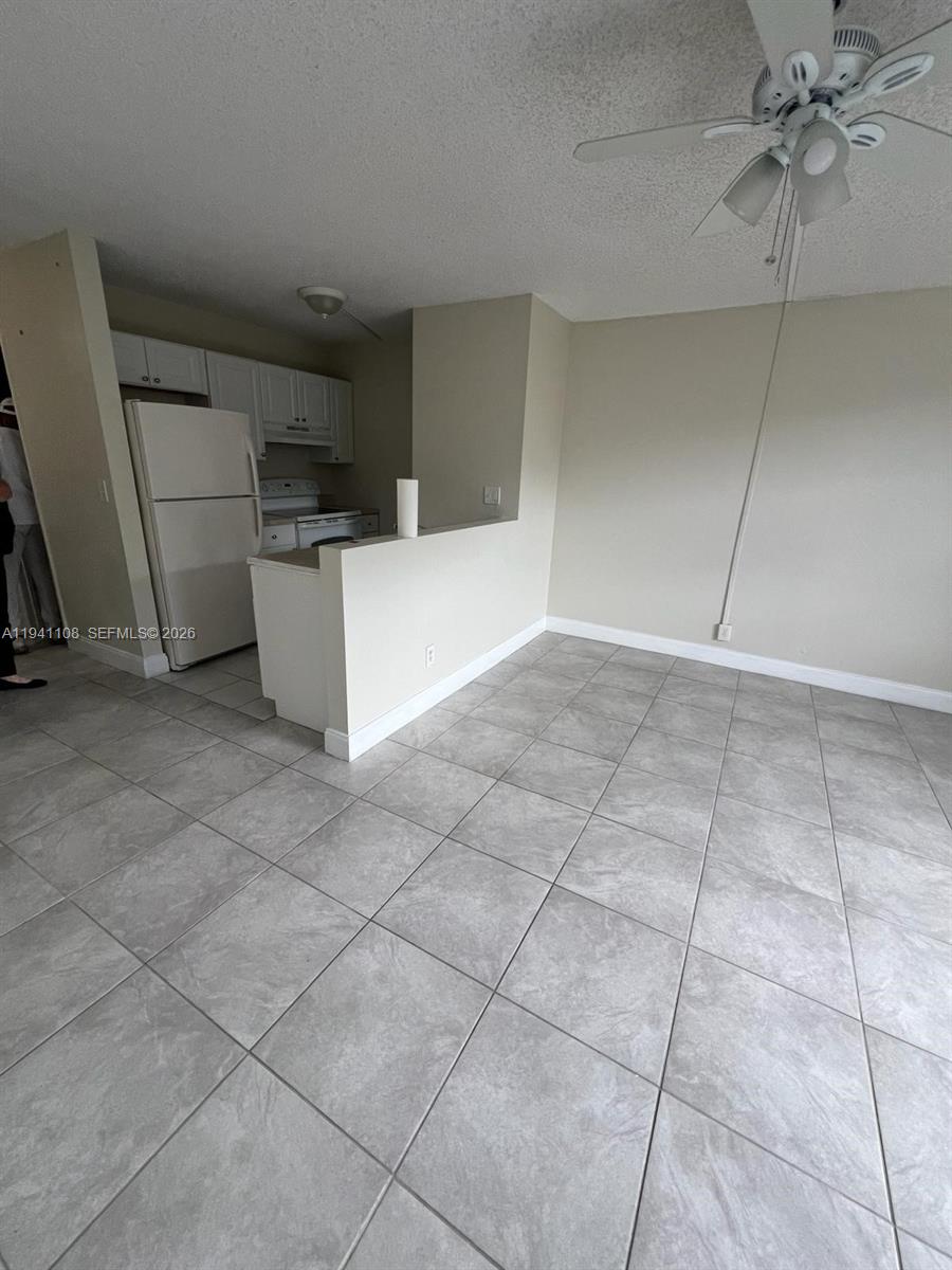 2701 Riverside Drive, Unit 308B Coral Springs, FL 33065 - Photo 1 of 9 a view of a kitchen with cabinets and a kitchen counter top space