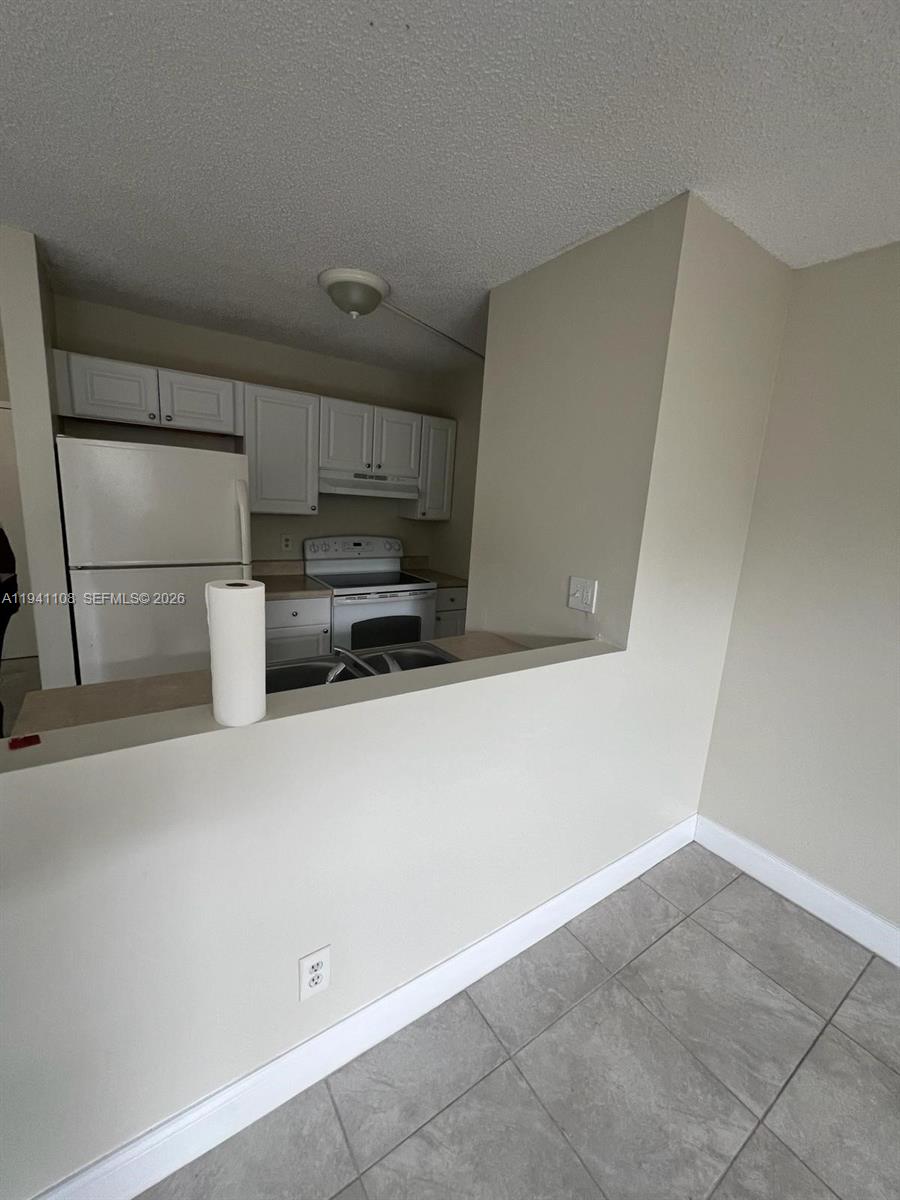 2701 Riverside Drive, Unit 308B Coral Springs, FL 33065 - Photo 6 of 9 a view of kitchen with refrigerator and microwave