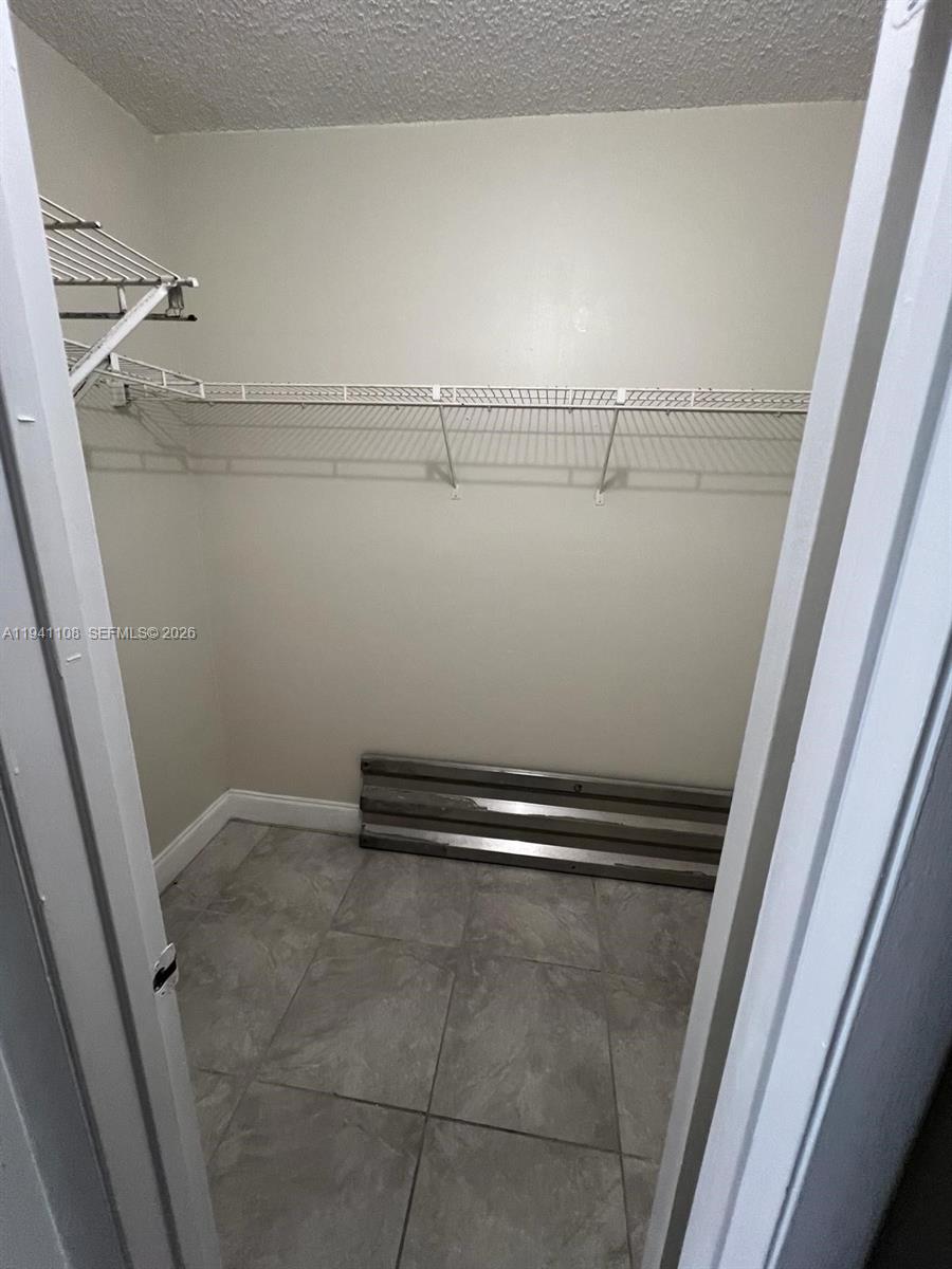 2701 Riverside Drive, Unit 308B Coral Springs, FL 33065 - Photo 9 of 9 a view of a room with racks on the wall