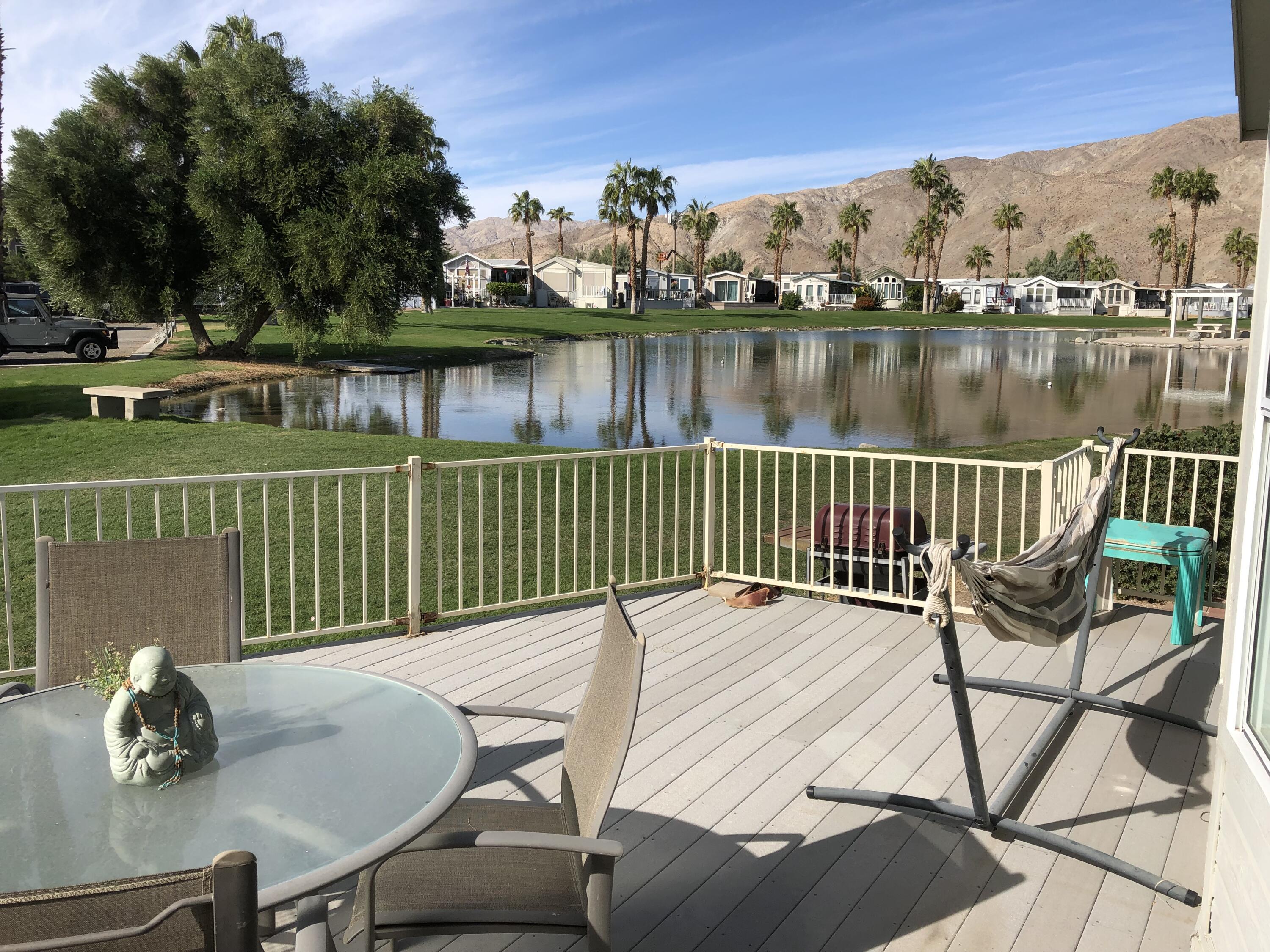 74711 Dillon Road Desert Hot Springs, CA 92241 - Photo 3 of 37 a view of a chairs and table on the deck