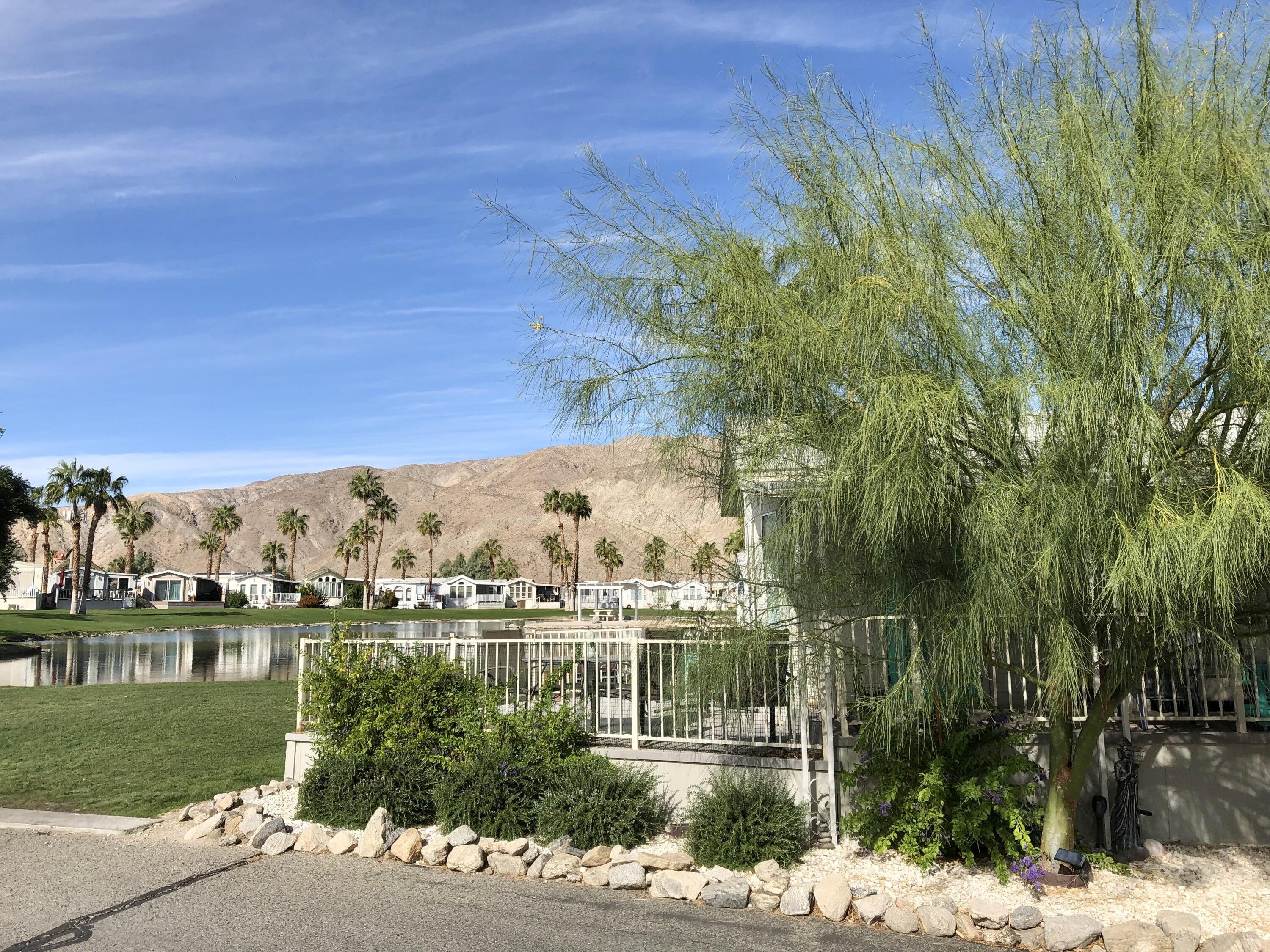 74711 Dillon Road Desert Hot Springs, CA 92241 - Photo 5 of 37 a view of a lake with a yard