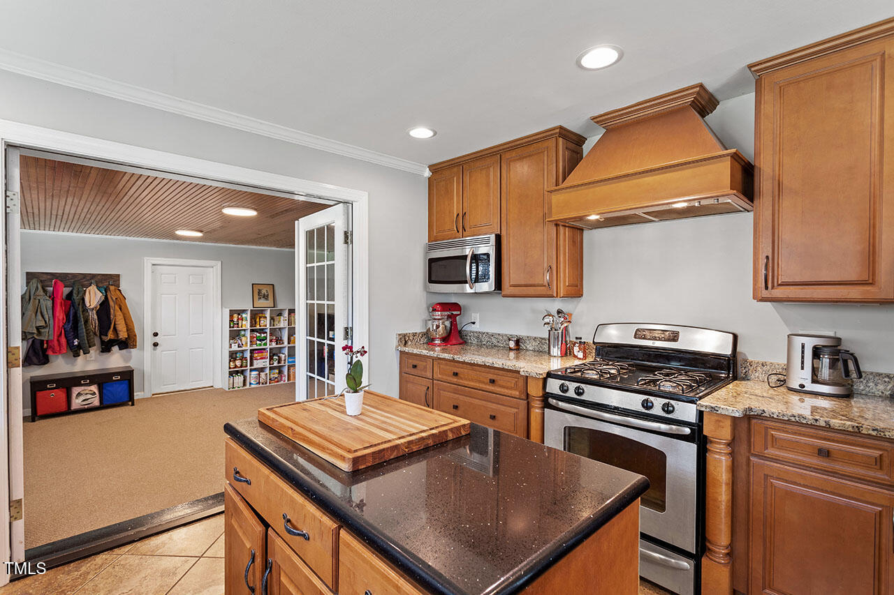 315 Golf Course Drive Raleigh, NC 27610 - Photo 18 of 44 a kitchen with kitchen island a stove a sink and a refrigerator