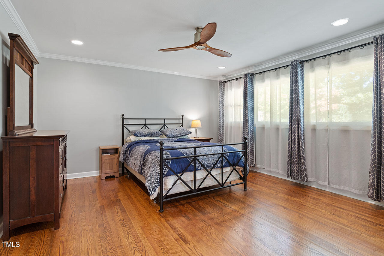 315 Golf Course Drive Raleigh, NC 27610 - Photo 23 of 44 a bedroom with a bed and wooden floor