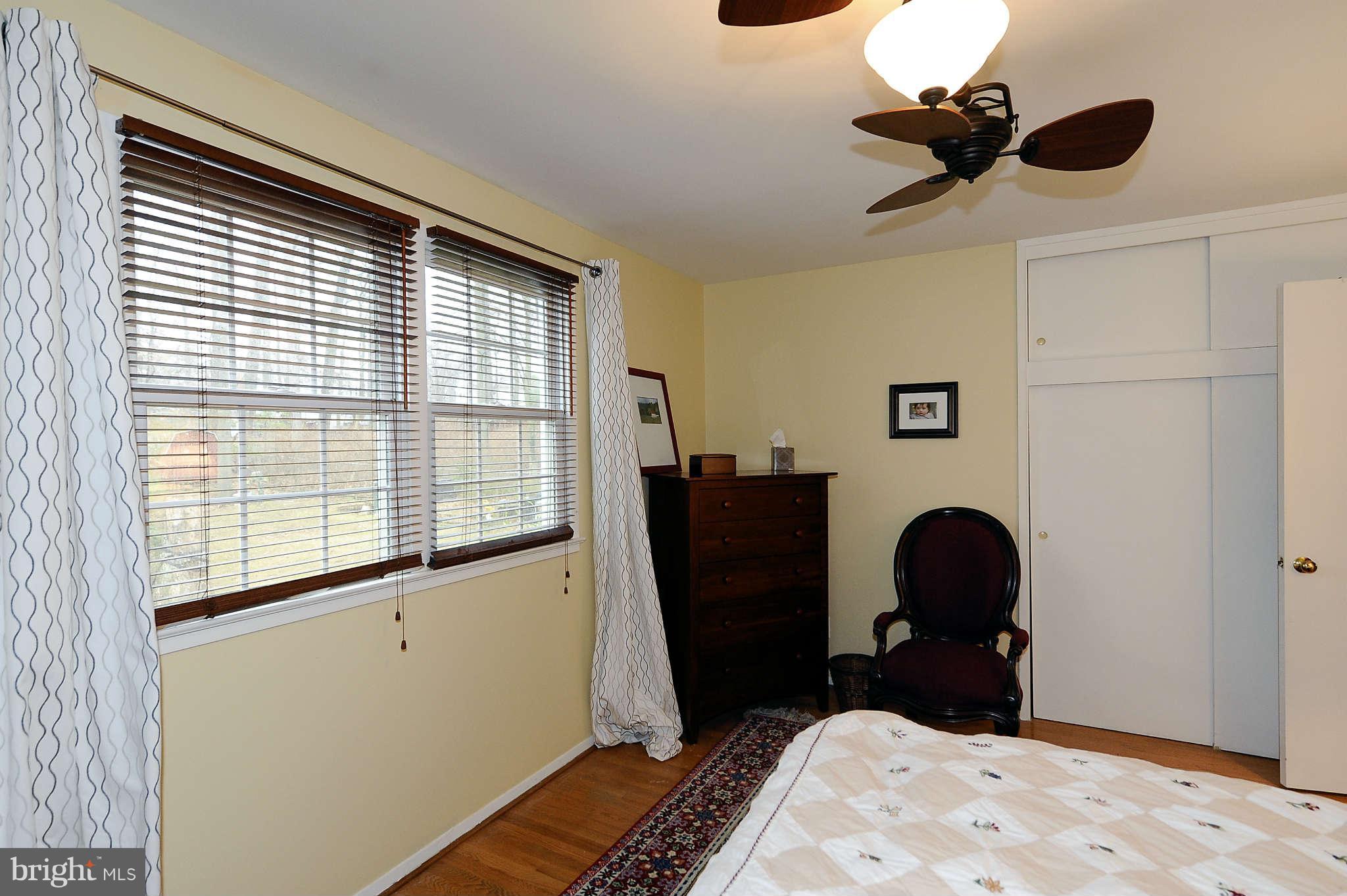 5411 Inverchapel Road Springfield, VA 22151 - Photo 12 of 22 a bedroom with a bed and a chandelier