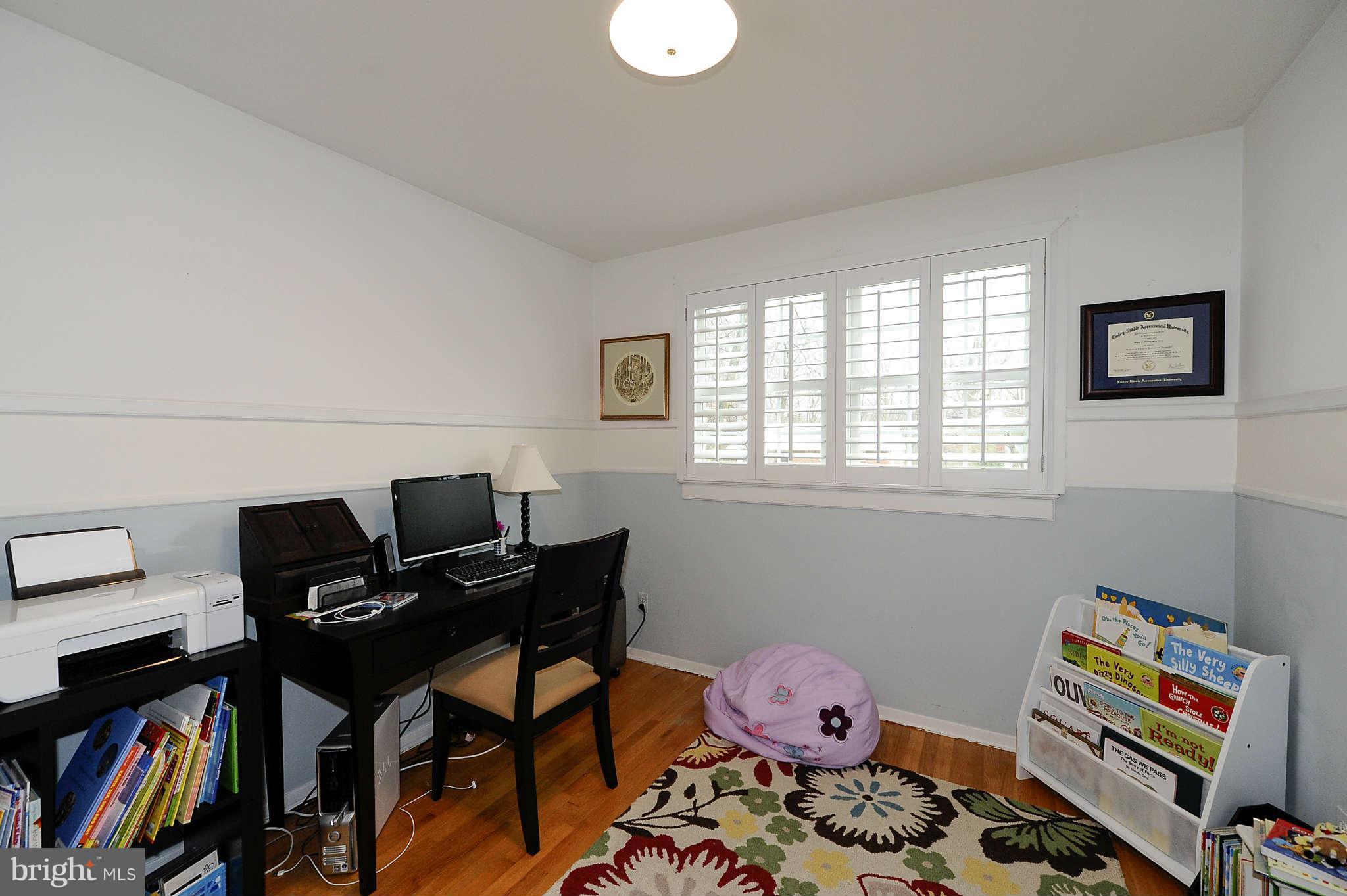 5411 Inverchapel Road Springfield, VA 22151 - Photo 17 of 22 a bedroom with furniture and a book shelf