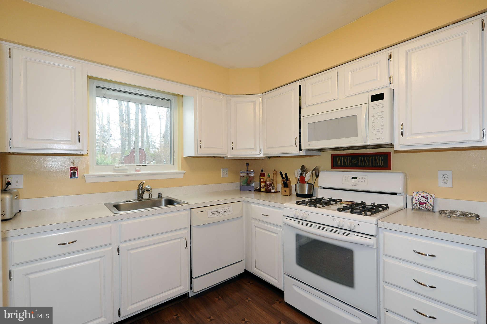 5411 Inverchapel Road Springfield, VA 22151 - Photo 9 of 22 a kitchen with white cabinets white stainless steel appliances and sink