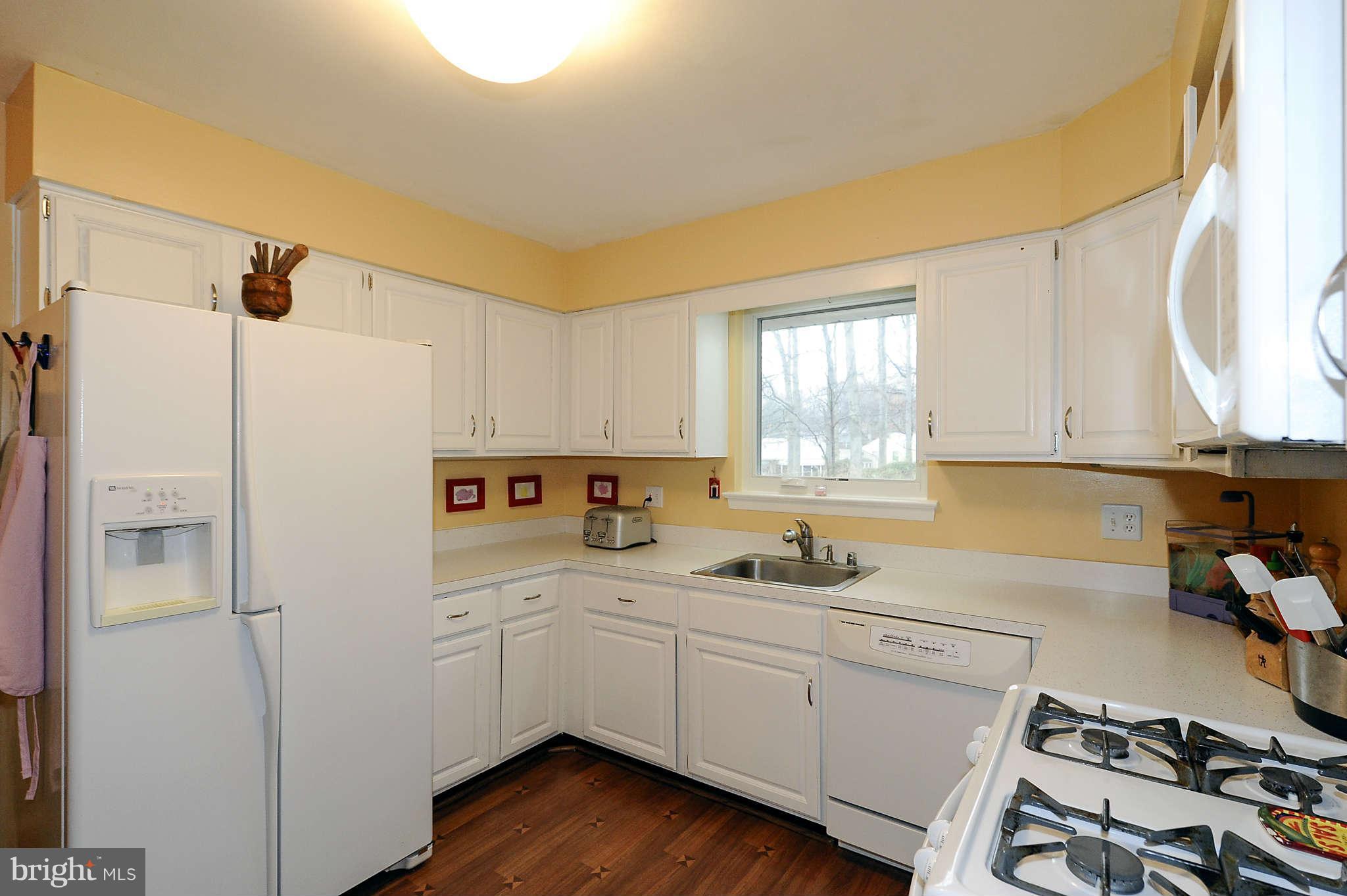 5411 Inverchapel Road Springfield, VA 22151 - Photo 10 of 22 a kitchen with a refrigerator a sink and wooden cabinets