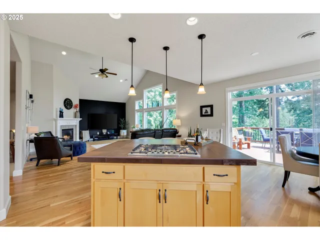 a kitchen view with living room furniture and a flat screen tv