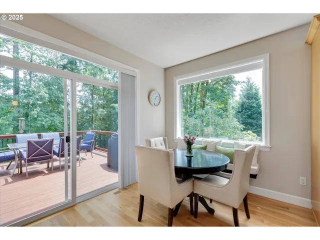 a dining room with furniture and large windows