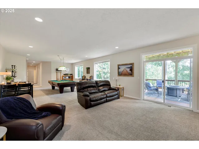 a living room with furniture and large windows