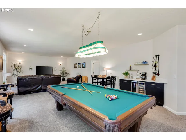 a room with pool table and windows