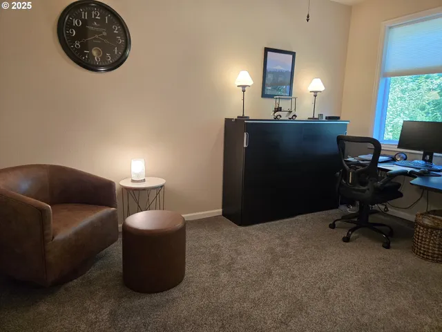 a view of a livingroom with workspace and a couch