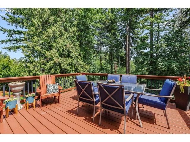 a view of a chairs and table on the roof deck