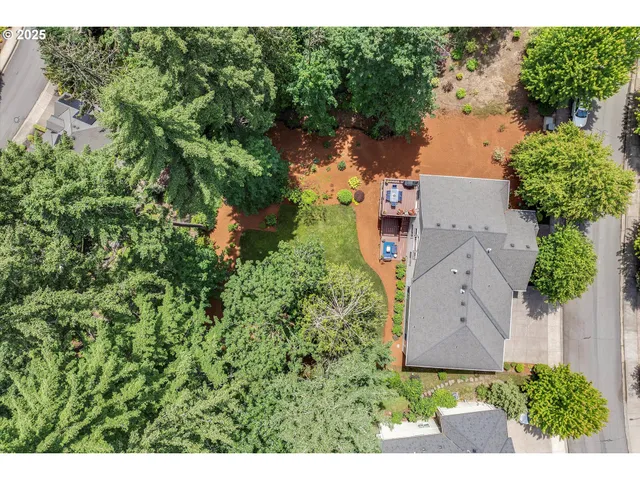 an aerial view of a house with a yard and garden