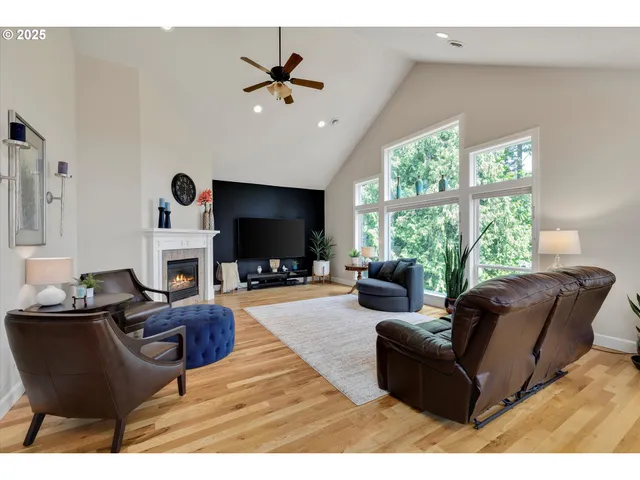 a living room with furniture a flat screen tv and a large window