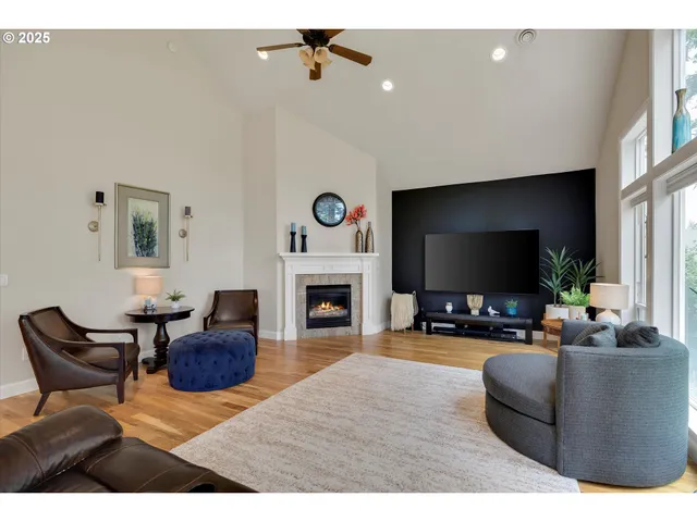 a living room with furniture a flat screen tv and a fireplace