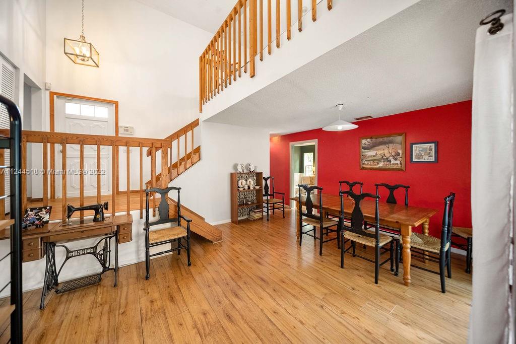 14914 Southwest 142nd Place Miami, FL 33186 - Photo 14 of 27 a view of a dining room with furniture and wooden floor