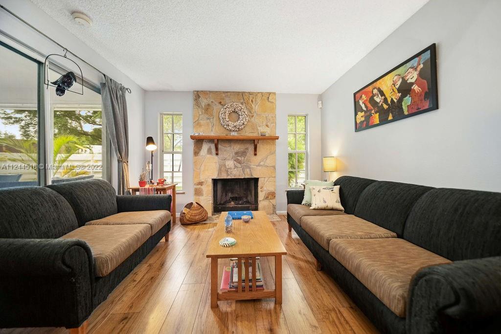 14914 Southwest 142nd Place Miami, FL 33186 - Photo 15 of 27 a living room with furniture and a fireplace