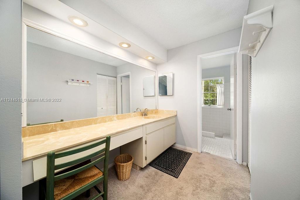 14914 Southwest 142nd Place Miami, FL 33186 - Photo 17 of 27 a bathroom with a sink a bathtub and a shower