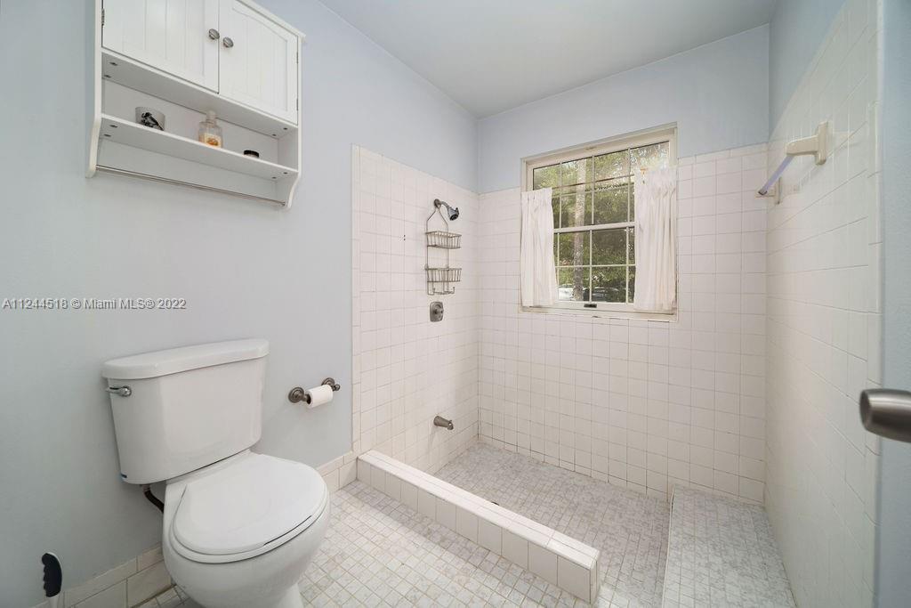 14914 Southwest 142nd Place Miami, FL 33186 - Photo 18 of 27 a white toilet sitting next to a bathroom sink