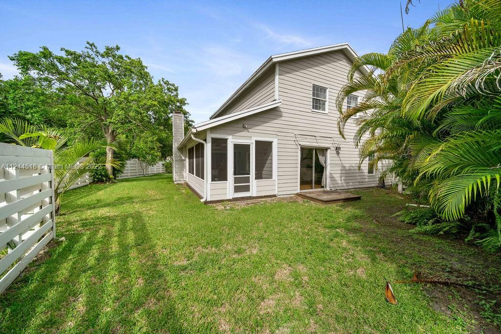 14914 Southwest 142nd Place Miami, FL 33186 - Photo 24 of 27 a front view of a house with a garden