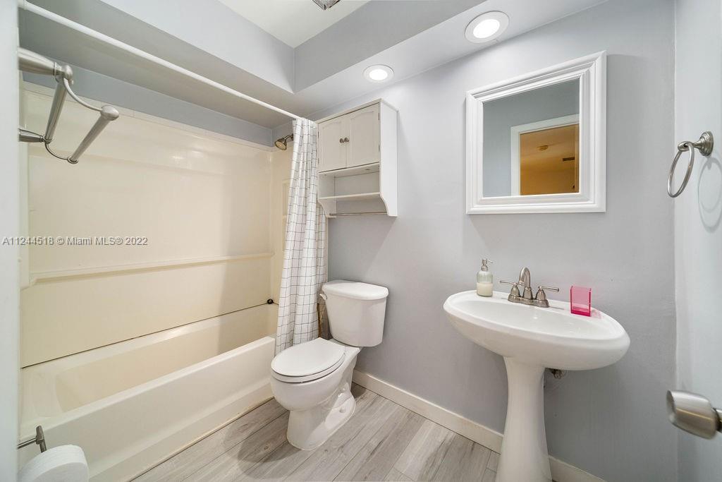 14914 Southwest 142nd Place Miami, FL 33186 - Photo 3 of 27 a bathroom with a sink toilet and shower