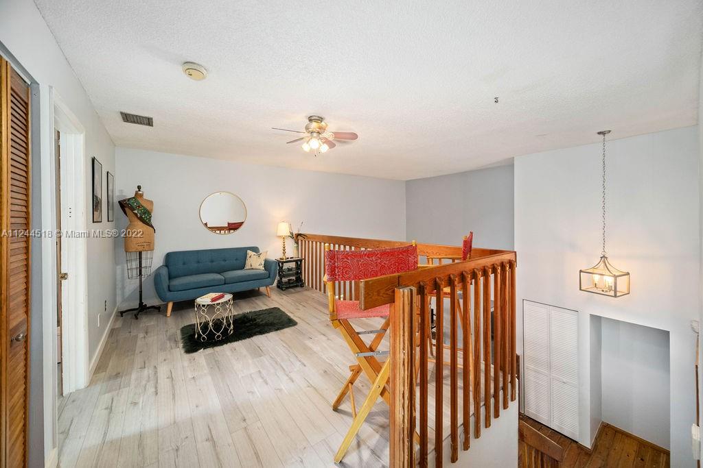 14914 Southwest 142nd Place Miami, FL 33186 - Photo 4 of 27 a bedroom with furniture and a wooden floor