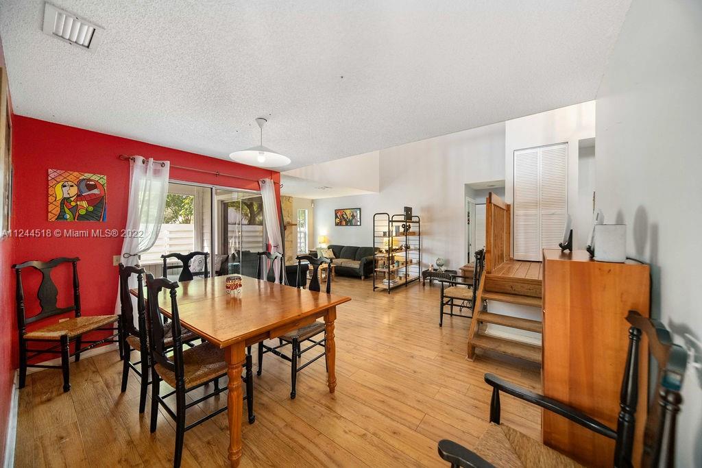 14914 Southwest 142nd Place Miami, FL 33186 - Photo 9 of 27 a view of a dining room with furniture window and wooden floor