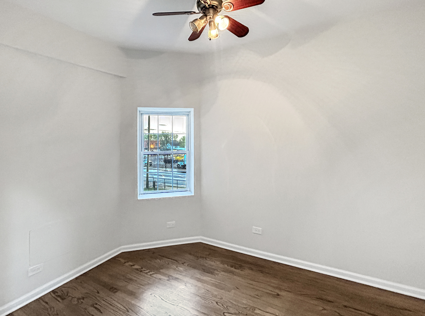 2953 West Warren Boulevard, Unit 2 Chicago, IL 60612 - Photo 17 of 31 an empty room with wooden floor chandelier fan and windows