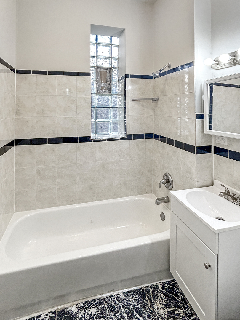 2953 West Warren Boulevard, Unit 2 Chicago, IL 60612 - Photo 26 of 31 a bathroom with a shower and a bathtub